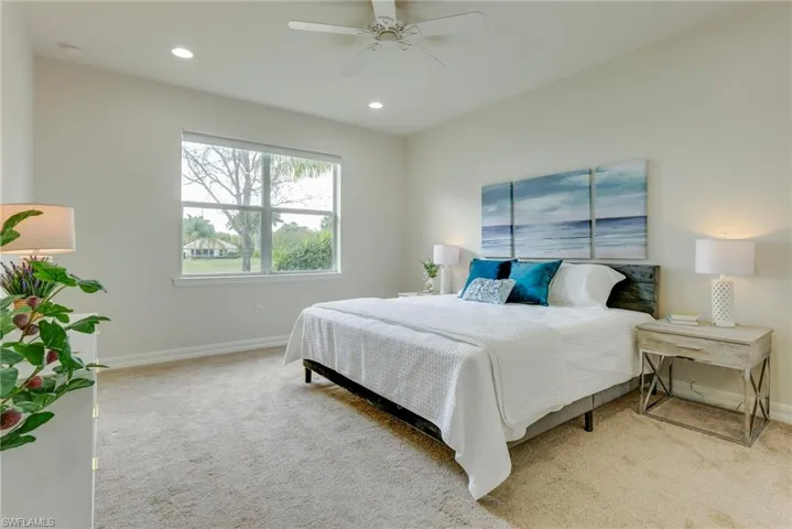 Bedroom featuring ceiling fan and light carpet