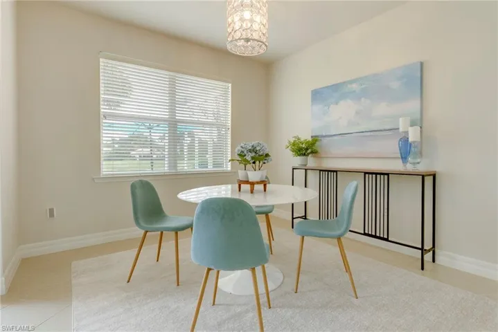 Dining area with a notable chandelier and light tile patterned floors