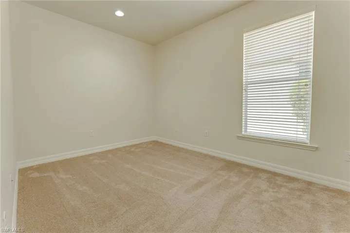 Empty room featuring light carpet