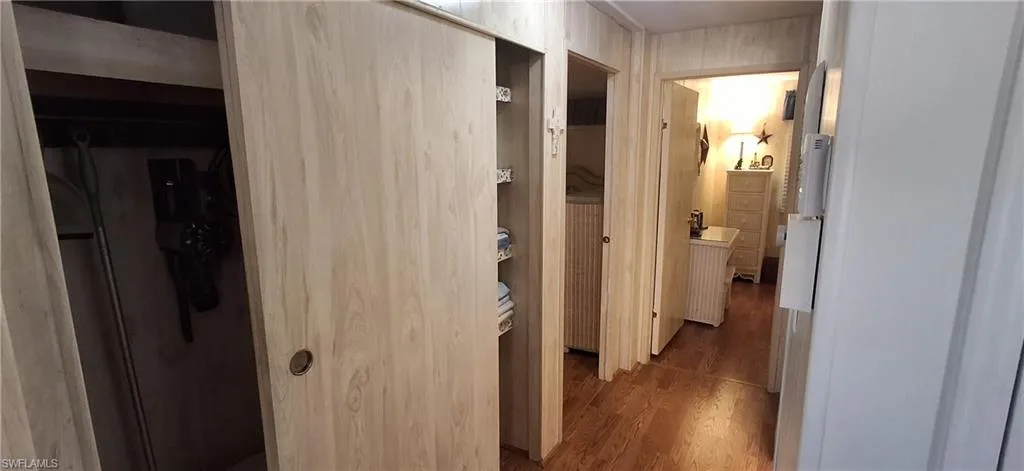 Hallway featuring two closets