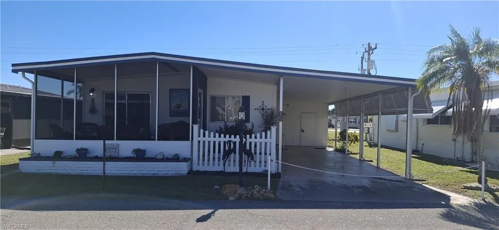 Inviting home with a sunroom, front lawn for the Pup and a carport