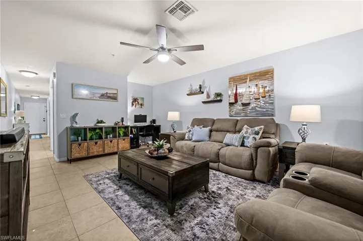 Open-concept living space featuring a ceiling fan, recessed lighting, and tile flooring