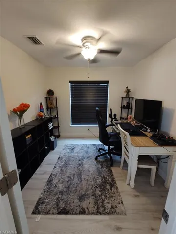 Office area featuring light wood finished floors and ceiling fan