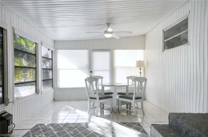 Sunroom with ceiling fan and a healthy amount of sunlight