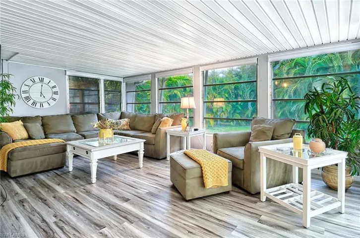 Sunroom / solarium with plenty of natural light and wood ceiling