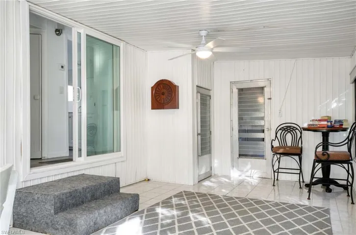 Sitting room featuring light tile patterned floors and ceiling fan