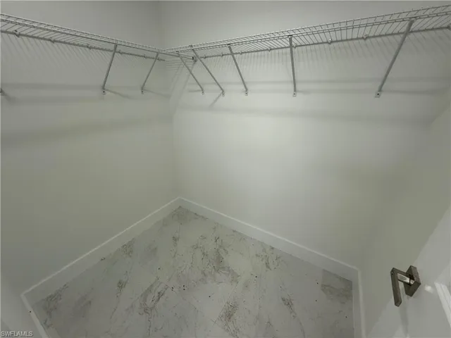 Walk in closet with marble look tiles
