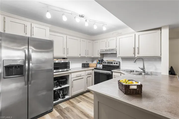 All stainless steel appliances are less than 5 years old! Wood shaker style cabinets. Tile countertops!