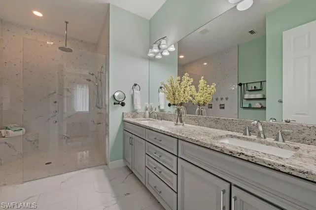 Expansive walk-in shower with a rain shower head and multiple body sprays