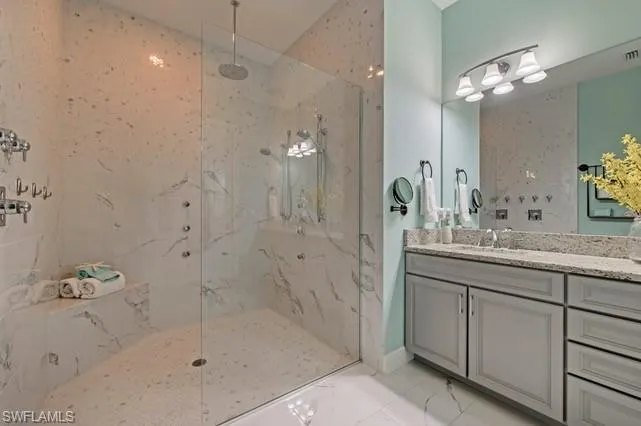 Spacious walk-in shower with full-height tile surround, built-in bench, and multiple shower heads