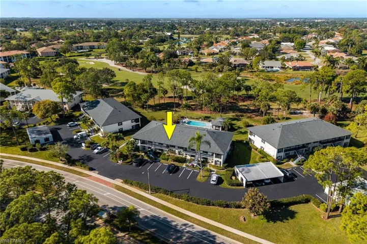 View of property location with a golf club and nearby suburban area