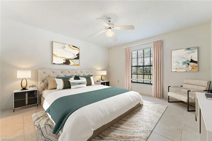 Bedroom with ceiling fan, a textured ceiling, and light tile patterned floors