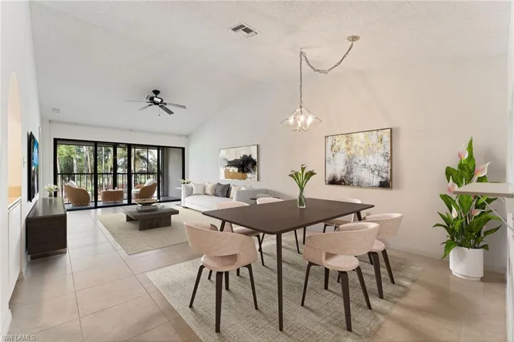 Dining room with a textured ceiling, a chandelier, a ceiling fan, high vaulted ceiling, and light tile patterned flooring
