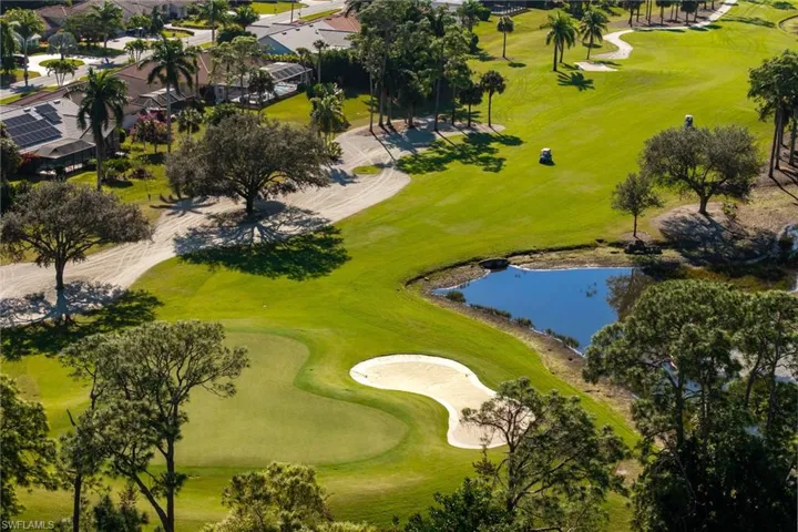 Aerial overview of property's location featuring a local golf course and a nearby body of water