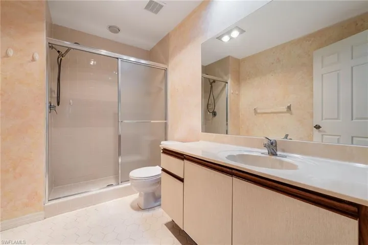Full bath featuring a shower stall and vanity