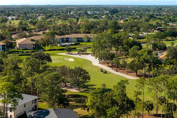 Aerial view of residential area featuring a golf club