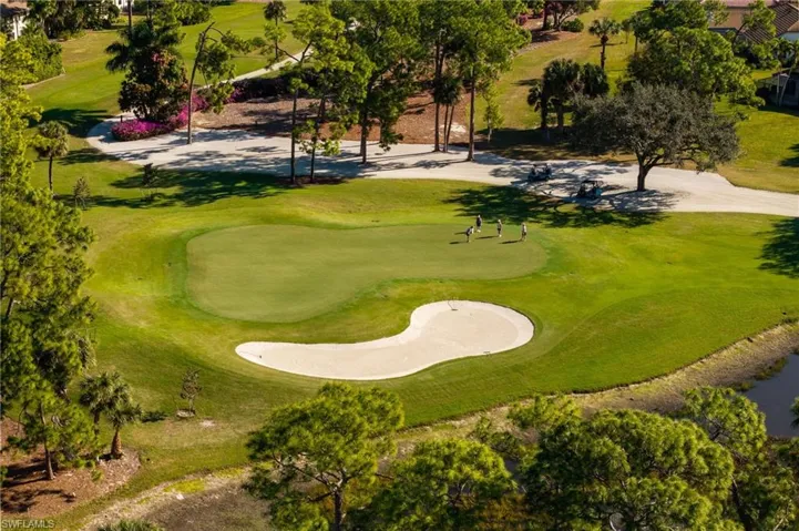 View of home's community with golf course view and a lawn