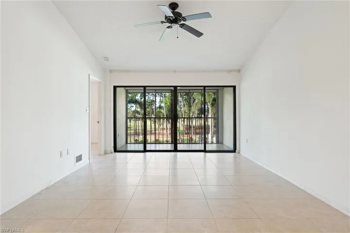Spare room featuring light tile patterned flooring, ceiling fan, and a textured ceiling