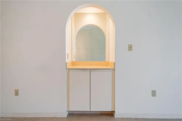 Empty room featuring baseboards and light tile patterned floors