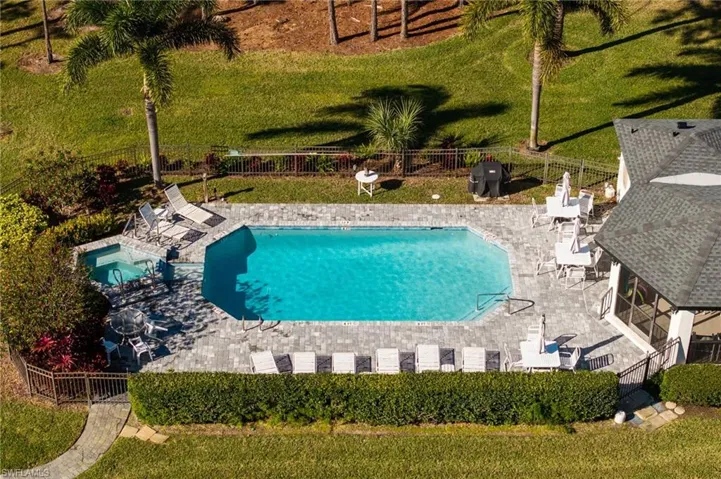 Community pool featuring a fenced backyard, a patio area, and a community hot tub