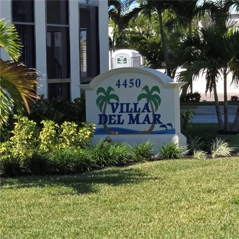 Community / neighborhood sign with a yard