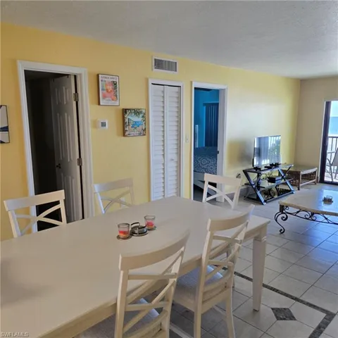 Dining room featuring light tile patterned floors and a textured ceiling