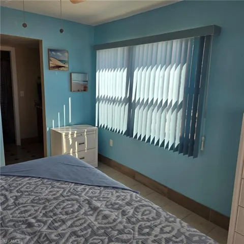 Tiled bedroom with baseboards