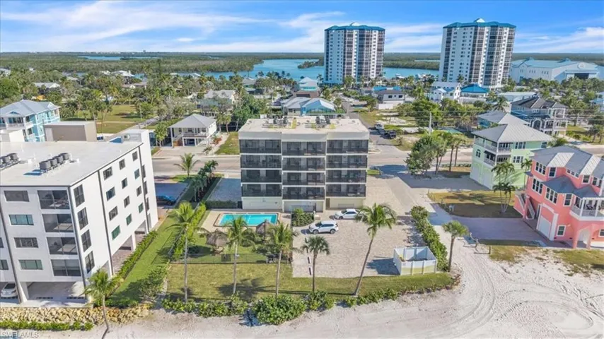 Drone / aerial view of a large body of water and apartment complex / building
