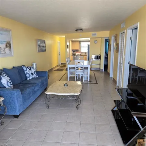 Living area featuring light tile patterned floors and baseboards