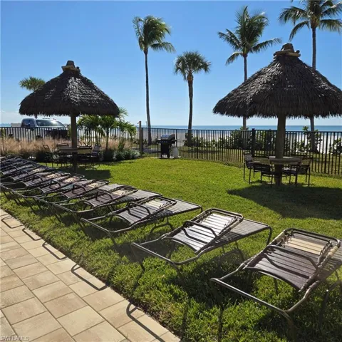 Surrounding community with a water view, a gazebo, and a patio