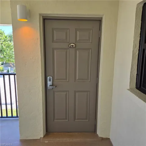Property entrance with stucco siding