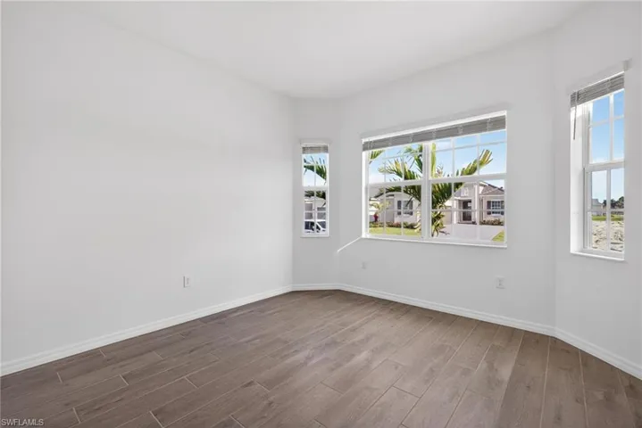 This room features numerous windows, providing abundant natural light and views of the surrounding neighborhood