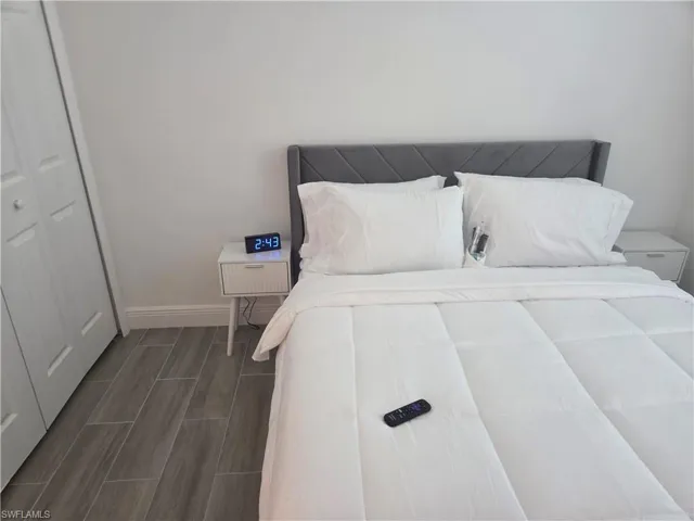 Bedroom with wood finish floors and a closet