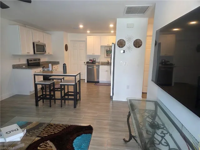 Living room featuring recessed lighting, wood finish floors, and ceiling fan