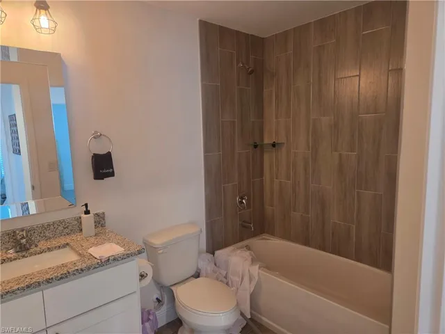 Bathroom with vanity and washtub / shower combination