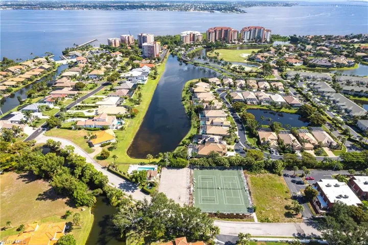 Aerial view of property's location featuring nearby suburban area and a nearby body of water