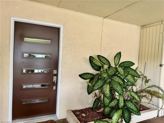 Property entrance with stucco siding