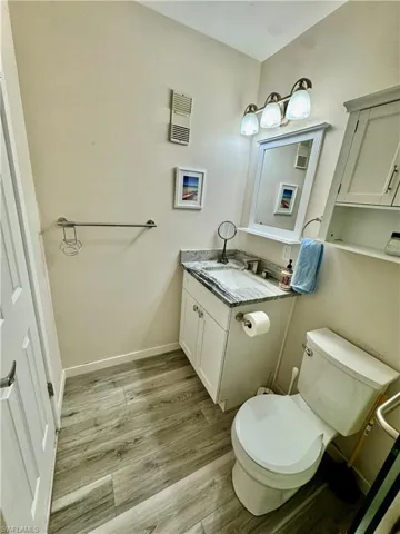 Half bathroom with vanity and light wood-type flooring