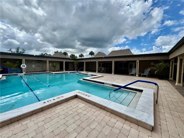 Community pool with a patio and a jacuzzi