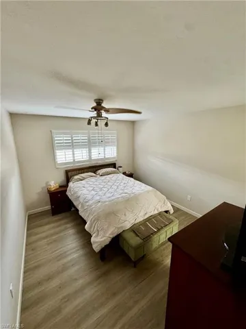 Bedroom featuring wood finished floors and ceiling fan