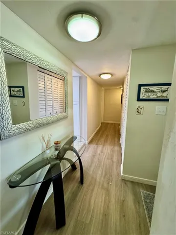 Hall featuring light wood-type flooring and baseboards