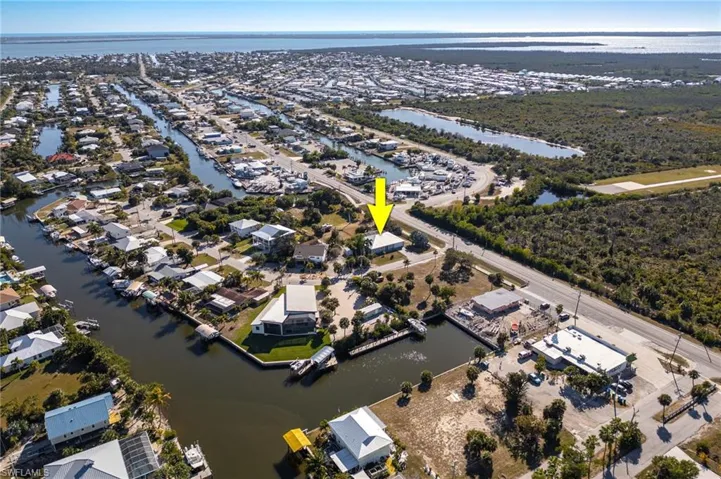 View of property location featuring a large body of water and nearby suburban area