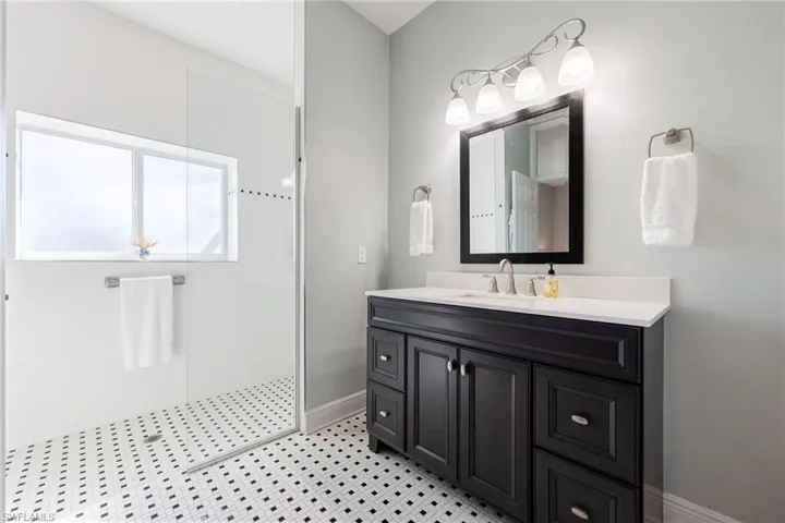 Bathroom featuring vanity and a walk in shower
