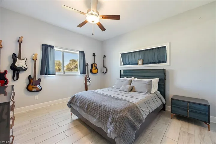 Bedroom with wood tiled floors and a ceiling fan