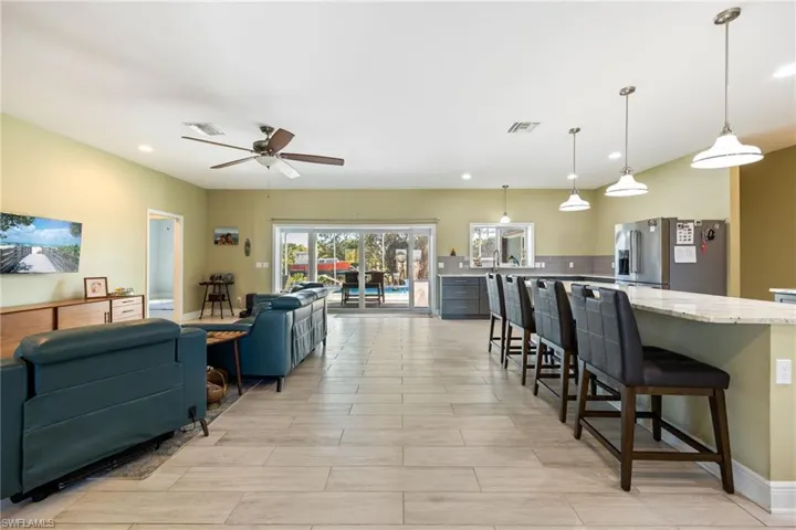 Living room featuring recessed lighting, ceiling fan, and wood finish floors