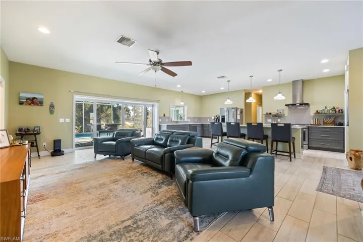 Living room with recessed lighting and a ceiling fan