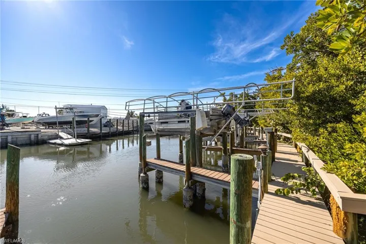 Dock area featuring boat lift and a water view