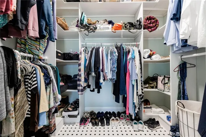 Walk in closet with light floors