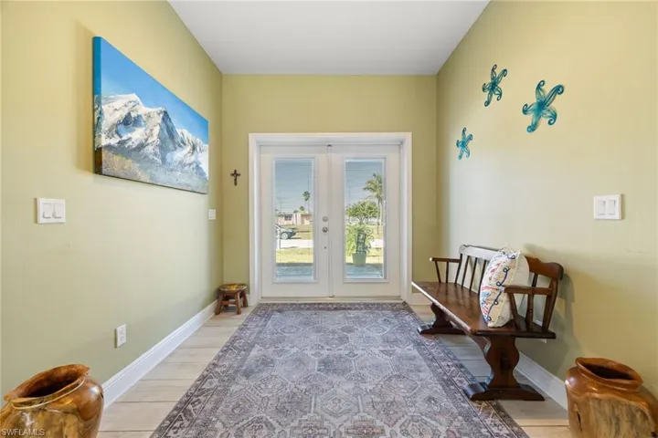 Doorway to outside featuring wood finished floors and french doors