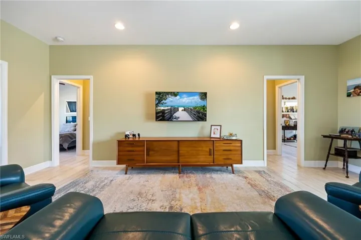 Living room featuring light wood-type flooring and recessed lighting